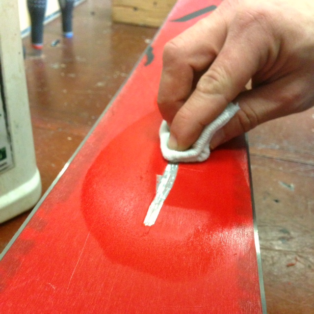 Cleaning ski core shot before applying base weld.