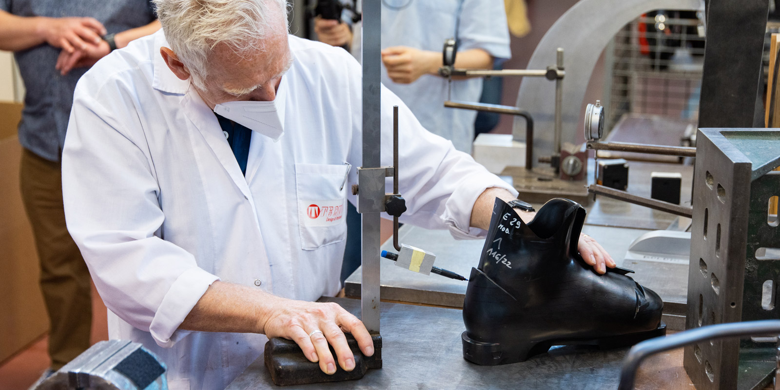 Nordica factory worker marking measurements on boot mold