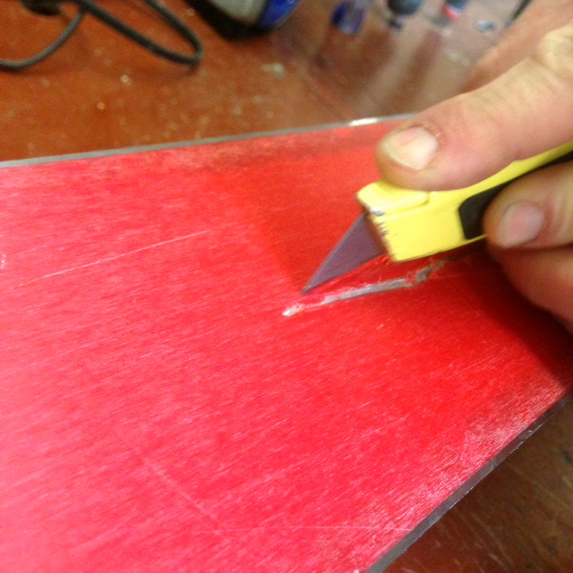 Cutting area around ski core shot. Preparing it for base weld.